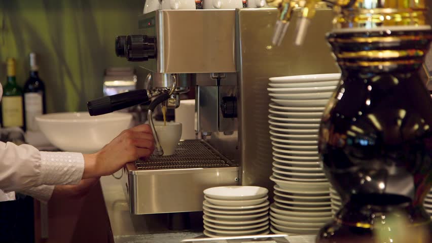 Barista Makes Coffee with a Professional Coffee Machine at a Bar. Barista, Bartender is a Person, Usually a Coffeehouse Employee, who Prepares and Serves Espresso Based Coffee Drinks.