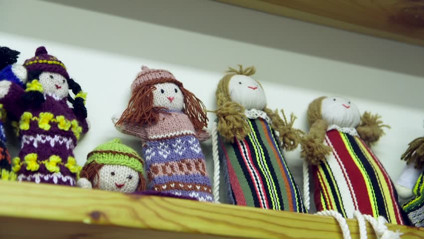 Beautiful Knitted Rag Dolls Arranged on a Shelf in a Children's Room or Shop. A Rag Doll is Made From Scraps of Fabric. One of the Oldest Childrens Toys in Existence.