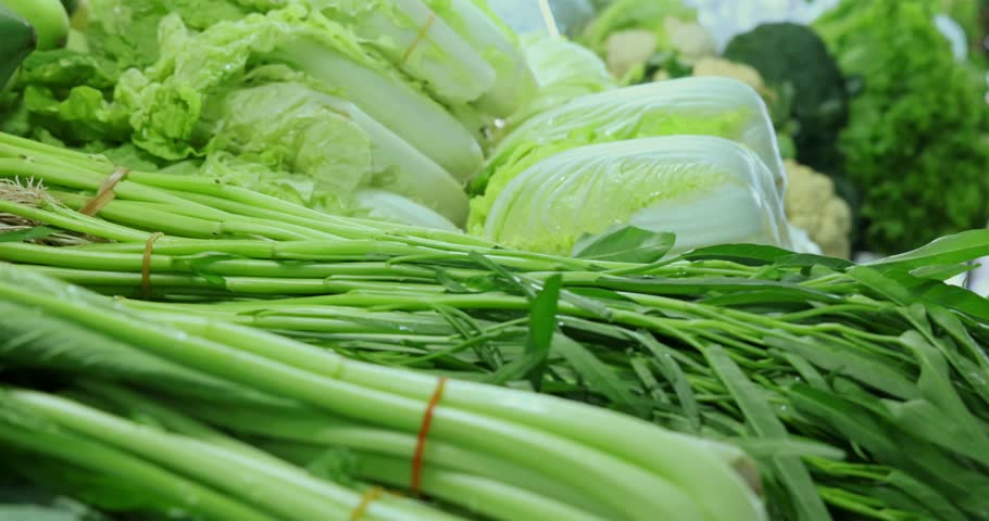 Fresh leafy greens on market display, rich in nutrition. Ideal for vegetarian food, healthy eating, produce stand, natural ingredients, wellness diet.
