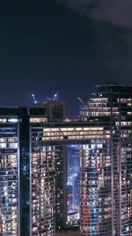 Night view of iconic skyscrapers and busy traffic on a major interchange in Downtown Dubai, UAE. Stunning skyline of a modern city, symbolizing business, finance, and urban development