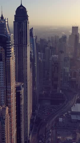 Aerial view of iconic skyscrapers and heavy traffic in Downtown Dubai, UAE. Modern skyline with luxury architecture, urban lifestyle, business district, finance hub, and smart city concept