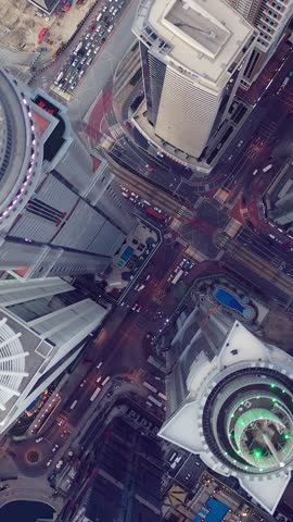 Aerial view of iconic skyscrapers and heavy traffic in Downtown Dubai, UAE. Modern skyline with luxury architecture, urban lifestyle, business district, finance hub, and smart city concept