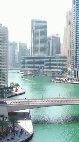 Aerial view of iconic skyscrapers and heavy traffic in Downtown Dubai, UAE. Modern skyline with luxury architecture, urban lifestyle, business district, finance hub, and smart city concept