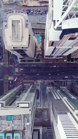 Aerial view of iconic skyscrapers and heavy traffic in Downtown Dubai, UAE. Modern skyline with luxury architecture, urban lifestyle, business district, finance hub, and smart city concept