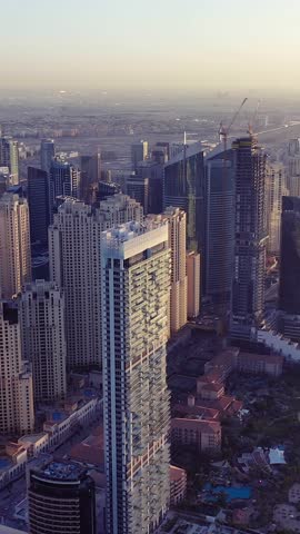 Aerial view of iconic skyscrapers and heavy traffic in Downtown Dubai, UAE. Modern skyline with luxury architecture, urban lifestyle, business district, finance hub, and smart city concept