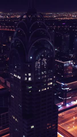 Night view of iconic skyscrapers and busy traffic on a major interchange in Downtown Dubai, UAE. Stunning skyline of a modern city, symbolizing business, finance, and urban development