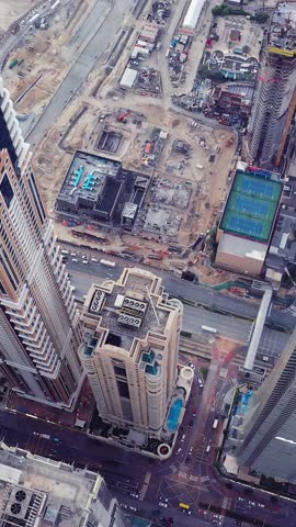 Aerial view of iconic skyscrapers and heavy traffic in Downtown Dubai, UAE. Modern skyline with luxury architecture, urban lifestyle, business district, finance hub, and smart city concept