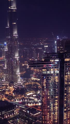 Night view of iconic skyscrapers and busy traffic on a major interchange in Downtown Dubai, UAE. Stunning skyline of a modern city, symbolizing business, finance, and urban development