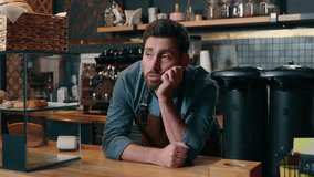 Disappointed Caucasian waiter man barista boredom in cafeteria exhausted employer problem bartender male entrepreneur leaning counter waitstaff overworking cafe guy contemplate small business stress - Powered by Shutterstock - Get 15% off with code: PIKWIZARD15