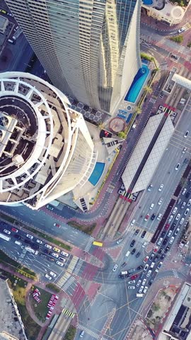 Aerial view of iconic skyscrapers and heavy traffic in Downtown Dubai, UAE. Modern skyline with luxury architecture, urban lifestyle, business district, finance hub, and smart city concept