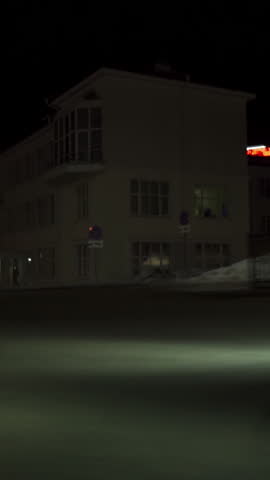 White car on highway, road, slow driving. Footage. View of car lights in night city.