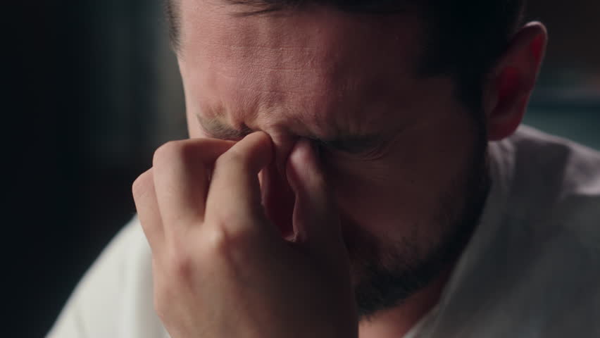Sleepy Caucasian designer worker close up businessman man take off glasses pain myopia in office overworked guy executive rubbing aching eyes male vision difficulty entrepreneur feel exhaust business