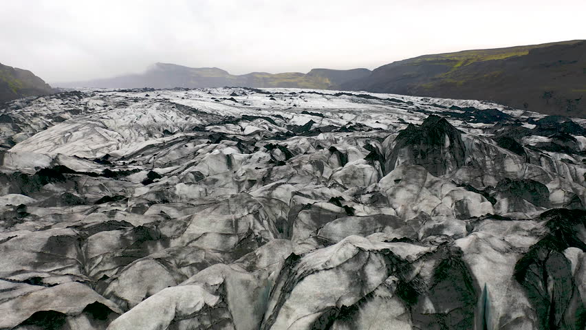 People hiking with crampons on the Solhrimajokull glacier in southeast Iceland.