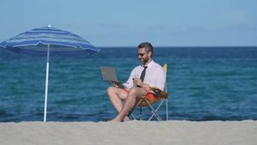 A freelancer enjoying remote work in a tropical paradise. A freelancer typing on a laptop under the sun beach. A businessman on vacation, working remotely. A businessman with a sea view. - Powered by Shutterstock - Get 15% off with code: PIKWIZARD15