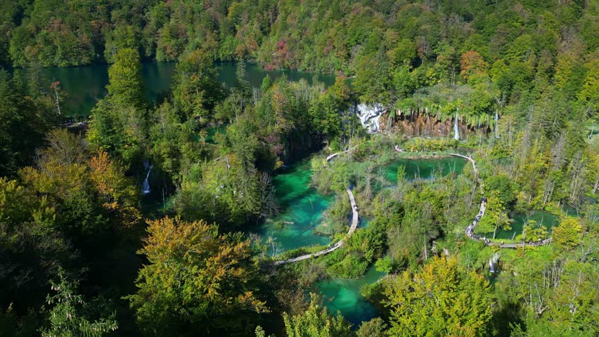 Beauty nature with waterfall. Panoramic aerial view of waterfalls. Beauty green nature. Plitvice lakes and Waterfall. Beauty waterfall landscape in Croatia. Crystal-clear water in Plitvice.