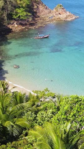 transparent blue sea with beautiful waves at sunny day in summer. Tropical landscape from the air of ocean with azure water, sandy bottom at sunset. Aerial view of sand beach. Video reel vertical styl