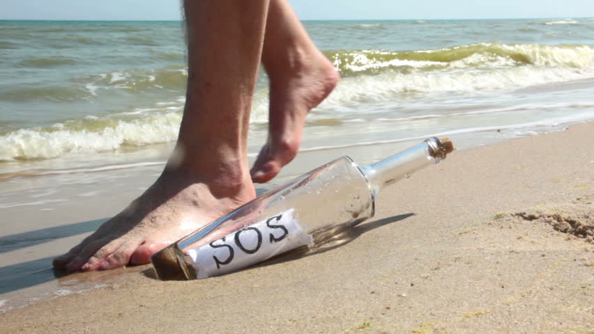 Beach. Sunny weather. Sand. Surf wave brought a bottle with a note inside. It