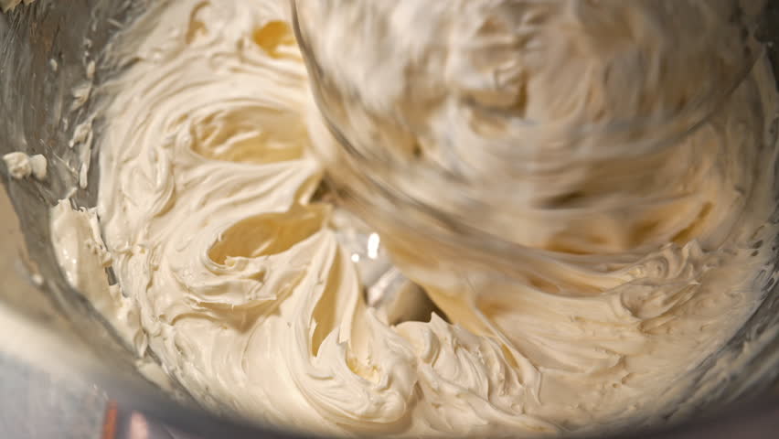 Stand mixer whipping cream for grease cake. Smooth creamy texture, fine pastries