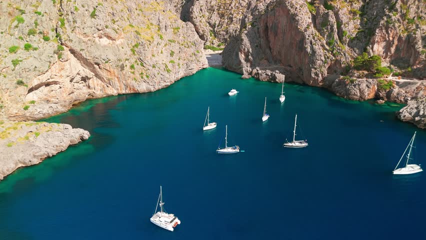 Aerial view of Sa Calobra Beach in Mallorca, Balearic Islands, Spain. Stunning hidden beach nestled between towering cliffs with crystal-clear turquoise waters, a popular summer destination on Majorca