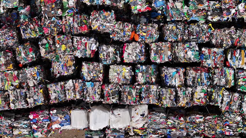 Piles of sorted recycled materials at a waste management facility