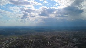 Aerial cityscape with dramatic sun rays breaking through clouds - Powered by Shutterstock - Get 15% off with code: PIKWIZARD15