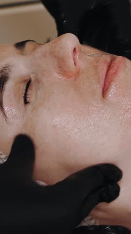 Beauty therapy. facial massage. Cosmetology skin care. close-up. woman is getting facial skincare massage, tonied facial skin and muscles, doing lymphatic drainage, at beauty clinic. anti-aging proced