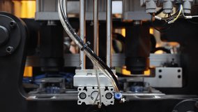 Close up of plastic PET bottle preform heating process in industrial manufacturing machine. Automated industrial PET bottle machine. Robotic system automation in high speed plastic bottle production. - Powered by Shutterstock - Get 15% off with code: PIKWIZARD15