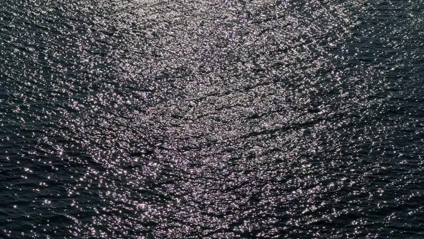 Glittering shiny sea water surface at night.