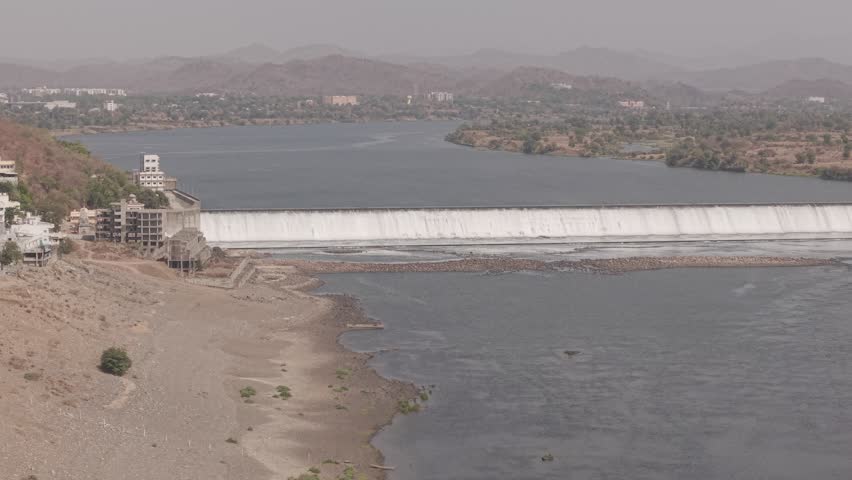 Scenic aerial drone footage capturing the peaceful beauty of an early morning sunrise near a dam.