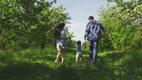 Mom dad kid daughter are play in garden happy child holds parents hands jumps. Happy family runs in park holding hands in spring summer. Happy childhood. Family holiday weekend Mother Father Daughter - Powered by Shutterstock - Get 15% off with code: PIKWIZARD15