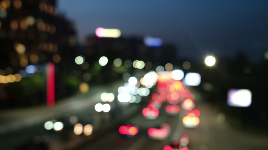 Blurred highway traffic at dusk with headlights and taillights with bokeh