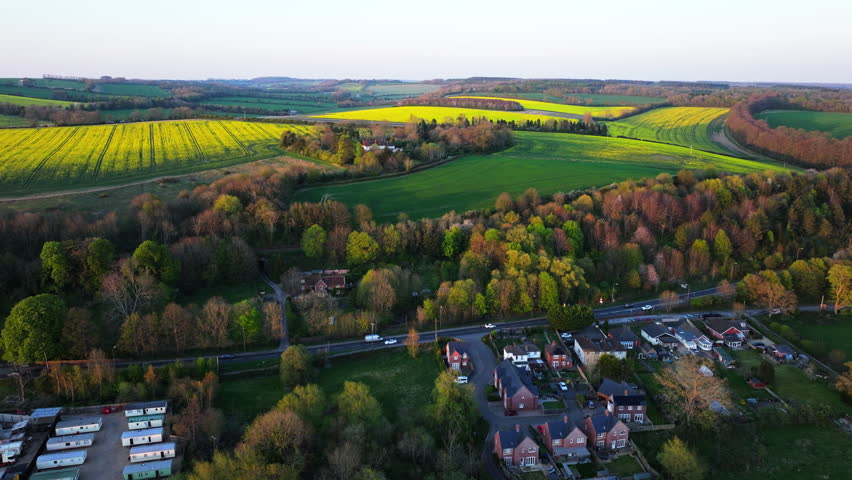 Aerial shot of forest and fields at sunset in Wiltshire, UK