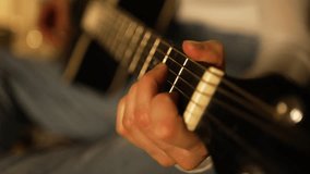 Skilled guitarist revealing intricate chord positions and strumming techniques while playing black acoustic guitar, displaying precise finger movements and musical expressiveness - Powered by Shutterstock - Get 15% off with code: PIKWIZARD15