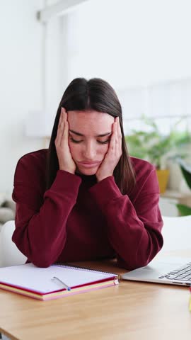 Young woman feeling stressed while working from home