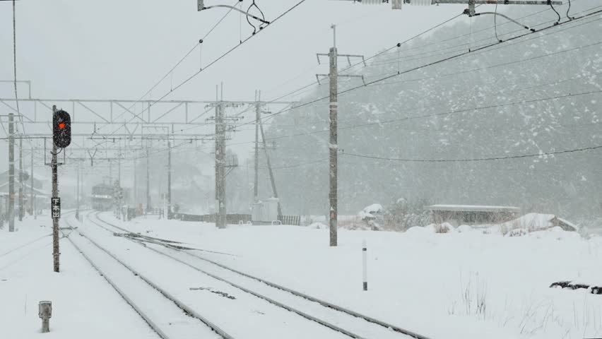 Snow Covered Railway Tracks and Signal in Winter Storm