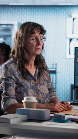 Vertical Video Old woman struggling with a severe migraine and asking for medicine, doctor putting up a recovery plan with strong painkillers treatment to relieve pain at checkup visit. Camera A.