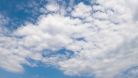 fast moving clouds against blue sky background, timelapse, 4k. Time lapse of fluffy clouds, Dynamic cloudscape featuring fast-moving, white clouds drifting across a vivid blue sky on a sunny day - Powered by Shutterstock - Get 15% off with code: PIKWIZARD15