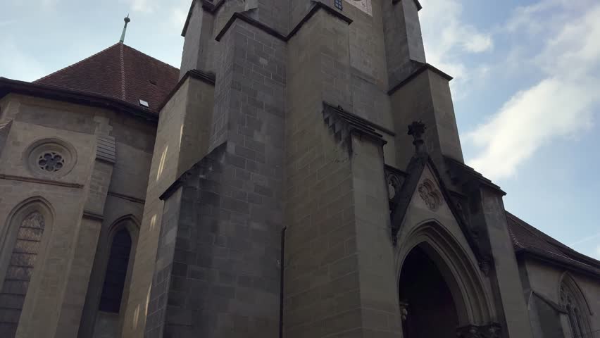 TILT SHOT - The reformed Church of St. Francis is a Protestant church located in Lausanne, Switzerland. It was begun in 1258 but burned in the 1368 city fire. The clock tower.
