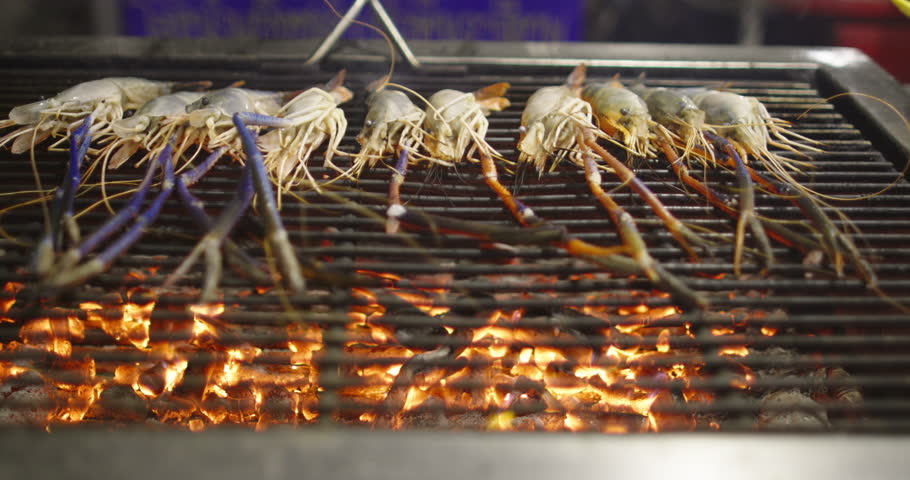 Grilled Shrimp on Charcoal BBQ Turned with Tongs for Healthy Thai Street Food