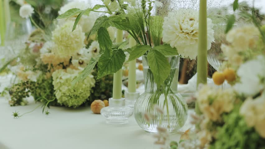  floral table setting complemented by soft candles and lush greenery. Wedding decor, banquet decor, tent decor, decorated tables,