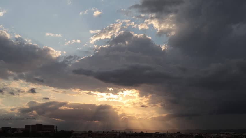 Dramatic Sunset Sky with Broken Clouds and Sun Rays