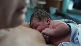 Gentle First Breastfeeding Moment - Young Mother Feeding Newborn at Hospital Post-Delivery, Highlighting Skin-to-Skin Bonding in Baby's Initial Minutes - Powered by Shutterstock - Get 15% off with code: PIKWIZARD15