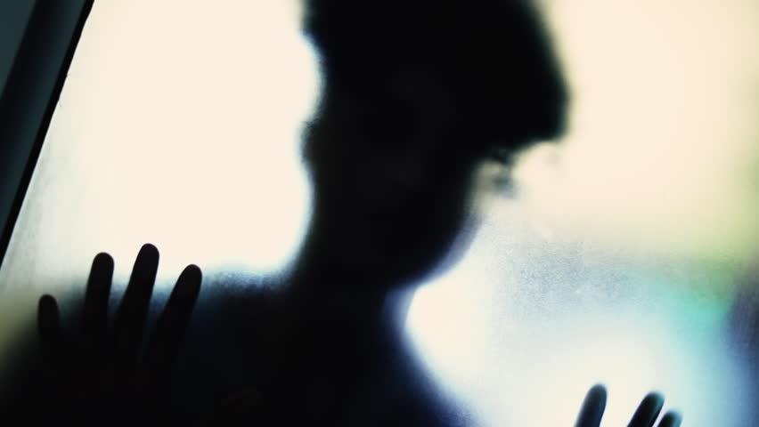 Shadowy Figure Behind Blurry Glass, Leaning in Mental Struggle, Depression Theme. Woman wanting to escape from entrapment