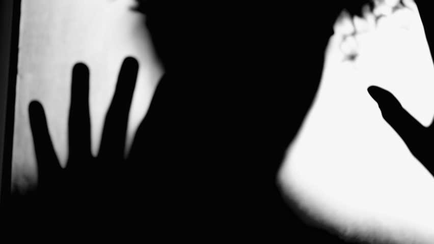 Silhouette of Person Trapped Behind Glass, Leaning in Despair, Depression Concept, Woman Longing for Liberation in black and white