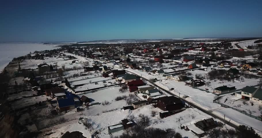 Village on the river bank in winter