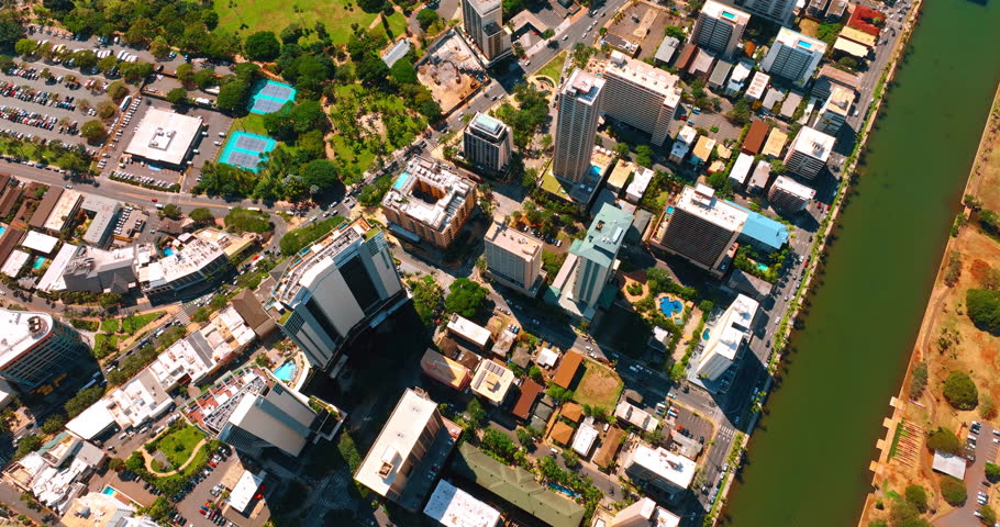 Flight over the urban landscape of Honolulu, Hawaii, USA. Drone footage above the Ala Wai Canal on sunny daytime.
