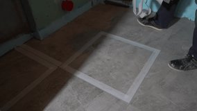 The masking tape is removed from the floor. Grouting of ceramic tile joints. The masking tape is removed from the floor. Cleaning after renovation. High quality 4k footage - Powered by Shutterstock - Get 15% off with code: PIKWIZARD15