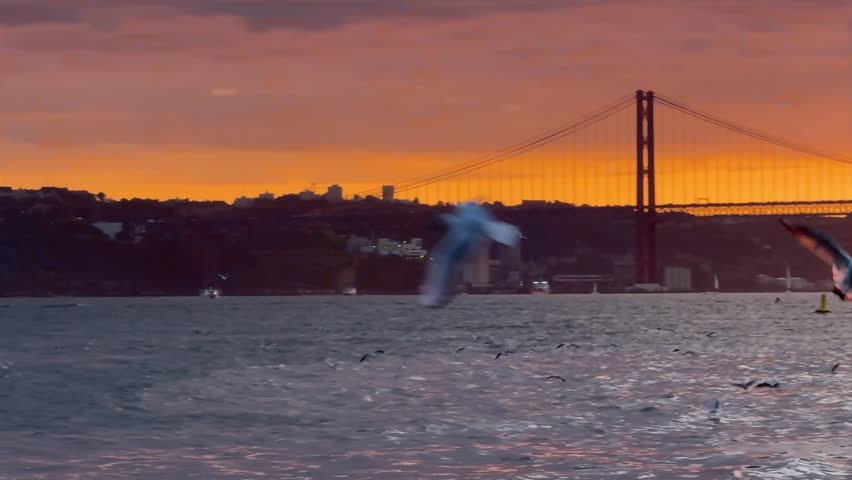 Views from the commerce square at sunset and 25 de abril bridge in background, Lisbon, Portugal.
