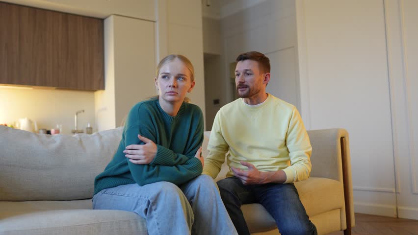 Furious betrayed wife confronts ashamed lying husband. Feared sad man desperately explains. Broken trust, painful betrayal, emotional confrontation, intense argument, relationship crisis, dishonesty