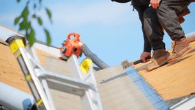 Roofer install new roof covering. installing a new roof on an house. - Powered by Shutterstock - Get 15% off with code: PIKWIZARD15
